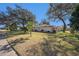 Landscaped front yard with mature trees and curb appeal at 10810 Cedar Breaks Dr, Port Richey, FL 34668