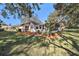 House exterior showcasing landscaping and screened patio at 10810 Cedar Breaks Dr, Port Richey, FL 34668