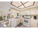 Kitchen with white appliances and light wood cabinets at 10810 Cedar Breaks Dr, Port Richey, FL 34668