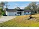 Single story house with yard and driveway at 1100 Belkton Ave, Port Charlotte, FL 33948