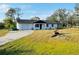 Single story house with yard and driveway at 1100 Belkton Ave, Port Charlotte, FL 33948