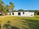 House backyard with grassy area and patio at 1100 Belkton Ave, Port Charlotte, FL 33948