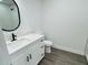 Clean bathroom with white vanity and vinyl plank flooring at 1100 Belkton Ave, Port Charlotte, FL 33948