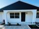 House exterior with dark roof and landscaping at 1100 Belkton Ave, Port Charlotte, FL 33948