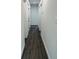 Clean hallway with dark vinyl plank flooring and white walls at 1100 Belkton Ave, Port Charlotte, FL 33948