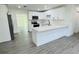 Modern kitchen with island, white cabinets and stainless steel appliances at 1100 Belkton Ave, Port Charlotte, FL 33948