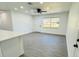 Bright living room with gray vinyl flooring and ceiling fan at 1100 Belkton Ave, Port Charlotte, FL 33948