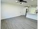 Bright living room with gray vinyl flooring and ceiling fan at 1100 Belkton Ave, Port Charlotte, FL 33948