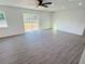 Spacious living area with sliding glass doors and vinyl plank flooring at 1100 Belkton Ave, Port Charlotte, FL 33948