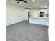 Bright living room with gray vinyl flooring and ceiling fan at 1100 Belkton Ave, Port Charlotte, FL 33948