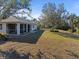 Spacious backyard with lush lawn and mature trees at 11346 Laffite Pl, Port Charlotte, FL 33981