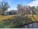 Home features a spacious backyard with a screened patio, overlooking a canal at 11346 Laffite Pl, Port Charlotte, FL 33981