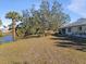 Large backyard with mature trees and canal views at 11346 Laffite Pl, Port Charlotte, FL 33981