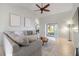 Living room with sectional sofa, ceiling fan, and sliding glass doors at 11346 Laffite Pl, Port Charlotte, FL 33981