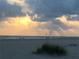 Sunrise over the beach with people enjoying morning on the shore at 1217 Aqui Esta Dr # 5, Punta Gorda, FL 33950