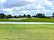 Picturesque golf course with water feature and lush green grass at 1217 Aqui Esta Dr # 5, Punta Gorda, FL 33950