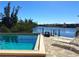 Community pool with canal view and lounge chairs at 1217 Aqui Esta Dr # 5, Punta Gorda, FL 33950