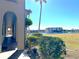 Waterfront view from covered walkway, lush landscaping at 1217 Aqui Esta Dr # 5, Punta Gorda, FL 33950