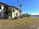 Building exterior showcasing waterfront access and lush landscaping at 1217 Aqui Esta Dr # 5, Punta Gorda, FL 33950