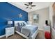 Bedroom with blue accent wall, queen bed, and ample natural light at 13264 Creekside Ln, Port Charlotte, FL 33953