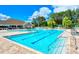 Inviting community pool with lap lanes, lounge chairs, and a spacious deck at 13264 Creekside Ln, Port Charlotte, FL 33953