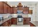 Kitchen with dark wood cabinets, granite countertops at 13264 Creekside Ln, Port Charlotte, FL 33953