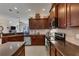 Kitchen features dark wood cabinets and stainless steel appliances at 13264 Creekside Ln, Port Charlotte, FL 33953