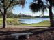 Tranquil landscape view of golf course and lake at 13264 Creekside Ln, Port Charlotte, FL 33953