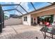 Relaxing screened patio with seating area and partial view of backyard at 13264 Creekside Ln, Port Charlotte, FL 33953