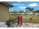 Red Kamado Joe grill on backyard patio at 13536 Ainsworth Ln, Port Charlotte, FL 33981