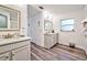 Modern bathroom with gray vanity and white quartz countertops at 13536 Ainsworth Ln, Port Charlotte, FL 33981