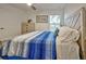 Bedroom with king-size bed and blue striped bedding at 13536 Ainsworth Ln, Port Charlotte, FL 33981