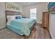 Bright bedroom with a comfortable bed and beach decor at 13536 Ainsworth Ln, Port Charlotte, FL 33981