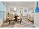 Dining area with a round glass table and four beige chairs at 13536 Ainsworth Ln, Port Charlotte, FL 33981