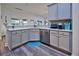 Kitchen with stainless steel appliances and grey cabinets at 13536 Ainsworth Ln, Port Charlotte, FL 33981