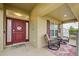 Covered porch with wicker chairs and a welcome mat at 13536 Ainsworth Ln, Port Charlotte, FL 33981