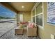 Relaxing screened porch with wicker furniture and view of backyard at 13536 Ainsworth Ln, Port Charlotte, FL 33981