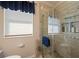 Bathroom with glass shower, decorative accents, and window at 1431 Grebe Dr, Punta Gorda, FL 33950