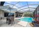 Enclosed pool and spa with patio furniture and relaxing ambiance at 1431 Grebe Dr, Punta Gorda, FL 33950