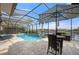 Enclosed pool and spa area with patio furniture and water view at 1431 Grebe Dr, Punta Gorda, FL 33950