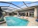 Enclosed pool and spa with patio furniture and water view at 1431 Grebe Dr, Punta Gorda, FL 33950