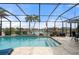 Enclosed pool and spa with patio furniture and water view at 1431 Grebe Dr, Punta Gorda, FL 33950