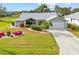 Single-story home with landscaped yard, driveway and palm trees at 157 Valdiva St, Punta Gorda, FL 33983