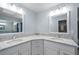 Double vanity bathroom with granite countertops and large mirrors at 157 Valdiva St, Punta Gorda, FL 33983