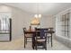 Dining room with table and chairs, view of kitchen and stainless steel refrigerator at 157 Valdiva St, Punta Gorda, FL 33983