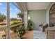 Cozy screened porch with wicker chairs and potted plants at 157 Valdiva St, Punta Gorda, FL 33983