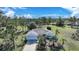 Aerial view of a single-Gathering house with a driveway and yard at 16161 Juarez Cir, Punta Gorda, FL 33955