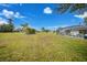 Expansive backyard featuring a grassy area and distant homes at 16161 Juarez Cir, Punta Gorda, FL 33955