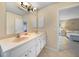 Bathroom with double sinks, and a view into the bedroom at 16161 Juarez Cir, Punta Gorda, FL 33955