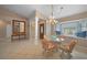 Bright dining area with a glass table, wicker chairs, and built in cabinetry at 16161 Juarez Cir, Punta Gorda, FL 33955